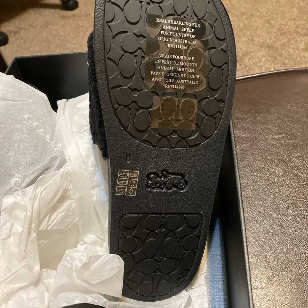 Brand new black and white authentic Coach slides.